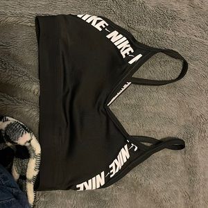 black nike sports bra with white lettering.